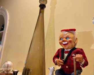 Vintage wind-up toy and smoked glass bottle
