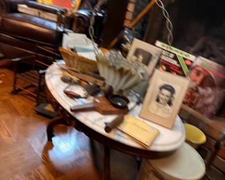Round wood table with collectibles and crocks