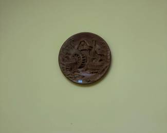 Carved round wood wall plaque