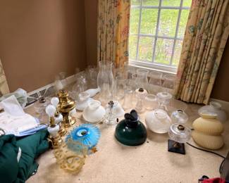 Collection of antique oil lamps and shades
