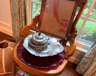 Silver tea set on antique wood chair