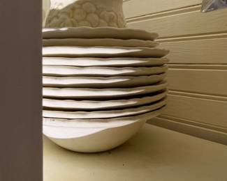 Stack of white ironstone plates and lidded jar