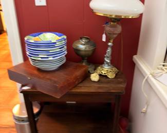 Milk glass parlor lamp and pottery bowls on table