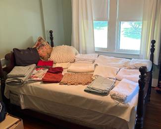 Assorted linens and full-size bed