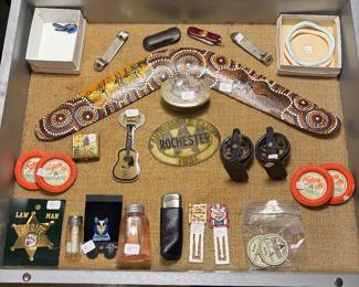 Wooden boomerang, bisque bracelets,  WWII pin, book marks and badge.