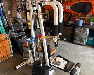 Weider System 3 Cross Trainer Home Gym with  a multi-station weight machine designed for full-body strength training. This machine features a 200 lb. weight stack labeled for bench press resistance.