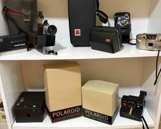 Polaroid Electric eye camera number 166, Polaroid wink light model 250, Polaroid time zone one step land camera, and number 2  model Brownie camera and book case.