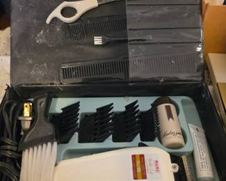 Wahl Multi-Cut clipper set includes electric clippers, four black plastic guide combs, and a cleaning brush