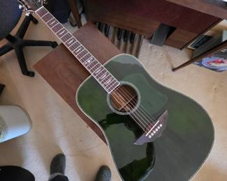 Keith Urban acoustic guitar features a dark green glossy finish and a distinct dreadnought body shape
