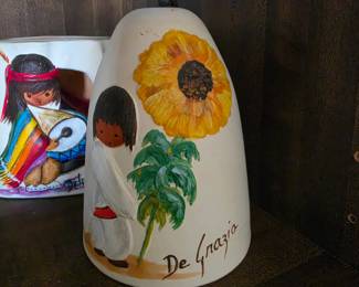 DeGrazia sandstone chime bell boy with a large sunflower