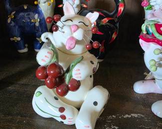 whimsical ceramic cat figurine by Amy Lacombe for Annaco Creations, part of her WhimsiClay holding cherries 
