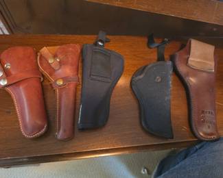 collection of vintage, brown and black leather, and nylon holsters