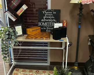 Desk, small book shelve for desk, lamps, fake plants, signs,