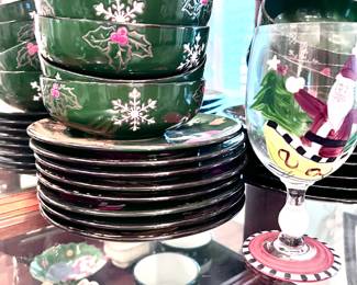 Collectible Christmas plates, cups, saucers, mugs, and wine glasses