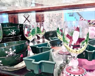 Collectible Christmas plates, cups, saucers, mugs, and wine glasses