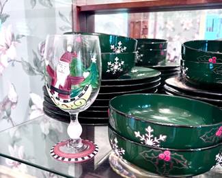 Collectible Christmas plates, cups, saucers, mugs, and wine glasses