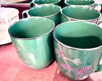 Collectible Christmas plates, cups, saucers, mugs, and wine glasses