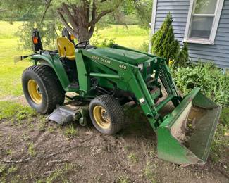 John Deere 4710 Tractor with bucket loader and brush hog