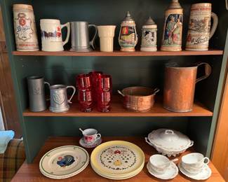 Vintage beer steins, metalware, ceramic dinnerware, ruby red glassware, and Austrian china.