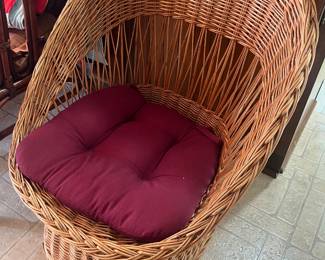 Mid-century modern-style wicker basket chair.