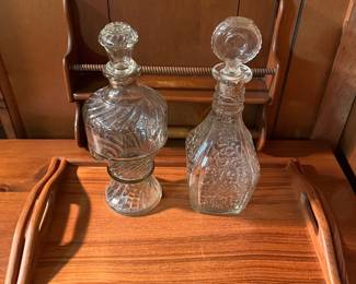 Vintage glass decanters and mid-century modern wooden serving trays.