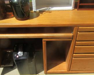 Blond computer station, wood matches bedroon furniture.