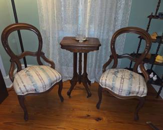 2 Victorian Balloon Back Hardwood Side Chairs with finger carving and newer upholstery circa 1880 Victorian Eastlake-style parlor table with geometric apron carvings and original metal casters. Circa 1880’s