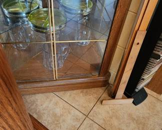 Corner cabinet, glassware, ceramic bowls, one piece of Uranium Glass
