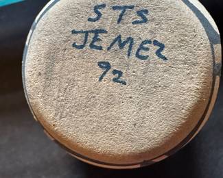 The "STS" signature on Jemez Pueblo pottery is generally associated with the artisan S.T. Sando. Artists from the Sando family, including Caroline Sando (known for her detailed nativity sets and figures) and others, are well-known for creating hand-coiled storytellers, kiva pots, and detailed clay ornaments