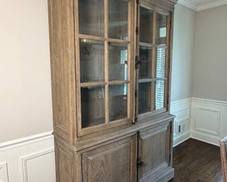 Restoration Hardware display cabinet with glass doors, cremone hardware, and weathered oak finish.