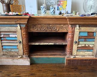Authentic Indian reclaimed wood cabinet featuring hand-carved details, colorful shutter-style doors, and architectural salvage construction.