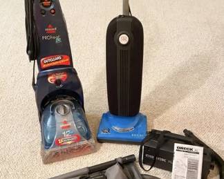 Electric vacuum cleaner, Bissell carpet shampooer and Oreck XL canister vacuum.