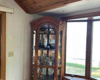 Two lighted oak and glass cabinets available