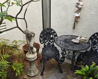 Cute vintage aluminum bistro set, concrete statue and pillar, shell decor, plants
