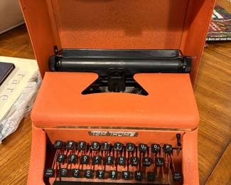 vintage Tom Thumb working toy typewriter in bright orange