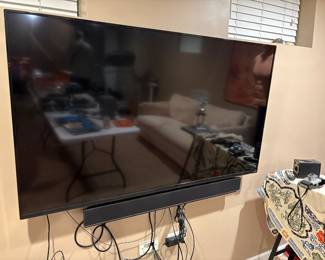 Vizio flatscreen TV, wall mounted with an optional stand