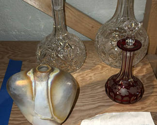 Lot 267: Crystal decanters, a heart-shaped vase, and a seaside tile