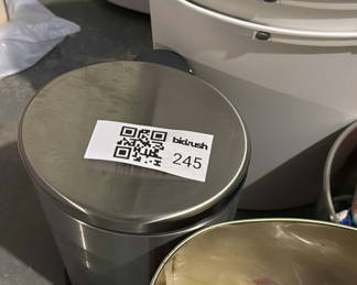 Lot 245: Assorted metal and plastic household trash cans and a cocoa tin