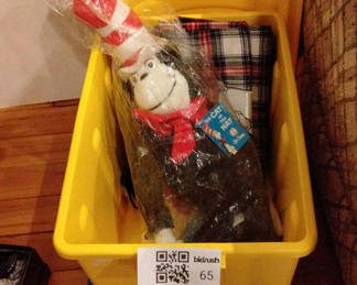 Lot 65: Disney and Dr. Seuss character clothing and plush toys with storage bin