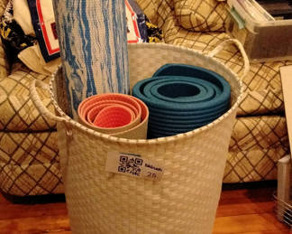 Lot 25: Basket with rolled yoga mats and a foam roller