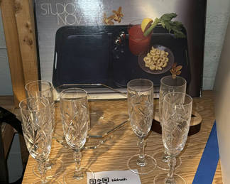 Lot 222: Crystal champagne flutes, octagonal glass centerpiece, and wooden inlay decorative piece