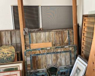 Now we start looking at the garage, including this set of stained glass windows hiding behind what looks like a bedframe (I could be wrong here, too.)