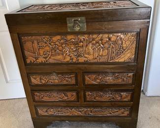 This sale has two of these intricately carved chests, both with Asian-inspired scenes.