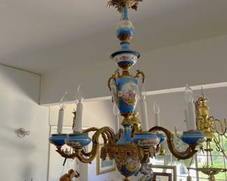 Hanging in the garage is this chandelier with blue accents.