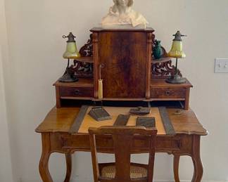 The desk on which the Tiffany desk set has a lot of classical styling. There is a closer view of the bust a little later in the pictures.