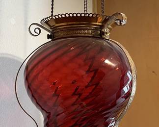 While also red, this hanging lamp does not match the others just seen, but as a stand-alone piece, it's great.