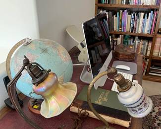 There are several items to note here: the globe, the two table lamps, and the bookshelf full of books in the background. Any one of those could make this sale worth it for you.