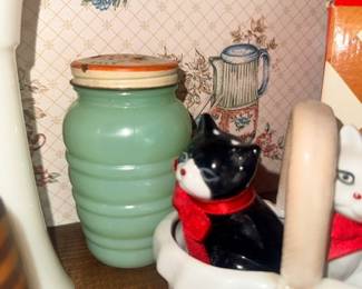 Ceramic cat figurine and green glass jar