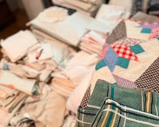 Table of vintage linens, quilts & blankets