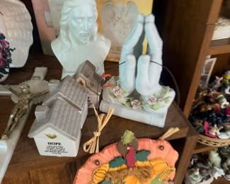 Religious bust statue and praying hands figurine